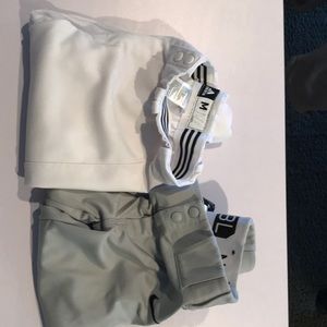 Adidas white baseball knickers and Nike gray baseball knickers.